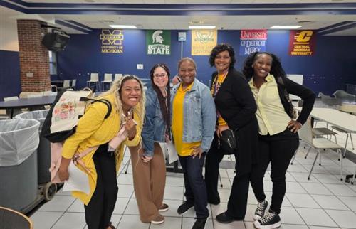 5 ladies smiling wearing their school colors